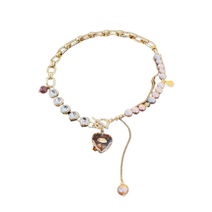Irregular heart charm bracelet with freshwater pearls and gold chain featuring T-bar clasp