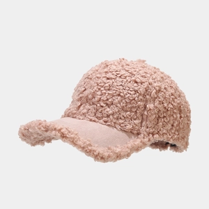Detailed view of pink fleece baseball cap showing soft faux shearling texture and suede brim