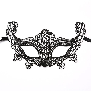 Close-up of elegant black lace mask with intricate baroque embroidery and satin ribbons