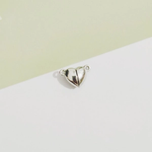 Macro shot of silver heart-shaped magnetic clasp connectors for DIY jewelry making