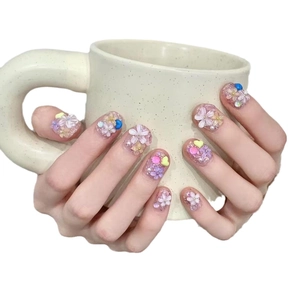 Handmade 3D floral press-on nails in cream white with colorful embossed petal designs