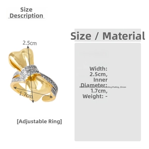 Detail view of gold bow ring dimensions with width 2.5cm and shiny cubic zirconia stones