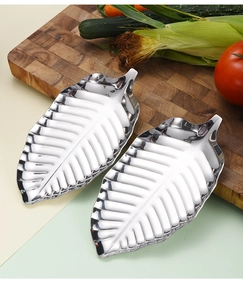 Macro detail of leaf-shaped silver stainless steel tray with intricate vein patterns