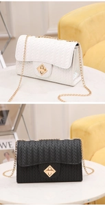 Detail of woven texture cross-body bag with gold metal lock and chain strap