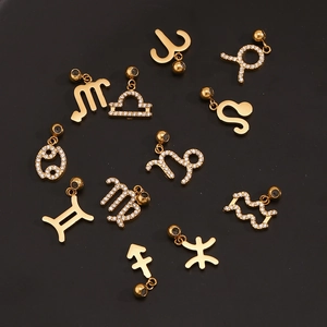 Macro shot of gold-plated zodiac pendants with sparkling white cubic zirconia inlay