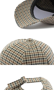 Detailed close-up of houndstooth fabric texture and adjustable metal buckle on baseball cap