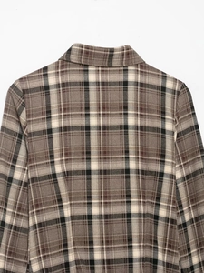 Detail of classic brown plaid shirt with standard collar and refined fabric texture