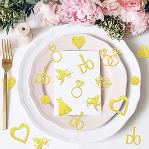 Golden glitter wedding confetti featuring heart, diamond ring and I DO shapes for table decor