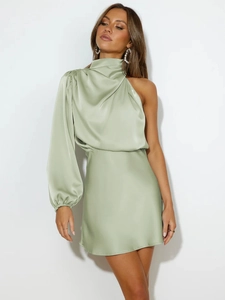 Detail of light green satin one-shoulder mini dress with elegant draped long sleeve texture
