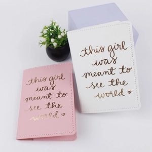Pink and white PU leather passport holders with gold world traveler quote and plant decor