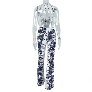 Rear view of zebra print two-piece set with backless halter top and flared trousers