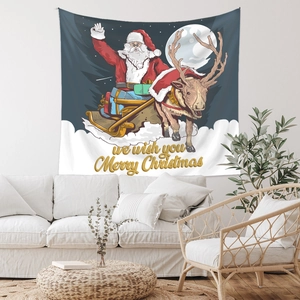 Close-up of a Christmas tapestry with Santa, reindeer, and golden holiday text on a white wall