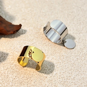 Minimalist 18k gold and silver titanium steel open rings with round charms on sand
