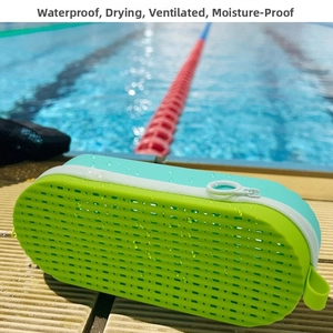 Waterproof silicone travel case with drainage holes on a poolside wooden deck