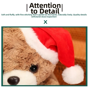 Close-up of soft brown Christmas teddy bear plush with a red Santa hat and black glossy nose