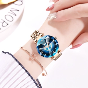 Detail of rose gold starry watch with blue faceted glass and matching star bracelet