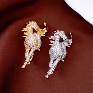Close-up of 14K gold and silver plated horse brooches with sparkling cubic zirconia