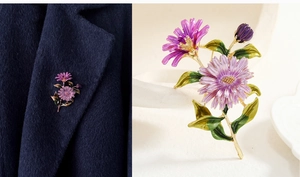 Detailed view of a purple enamel floral brooch with gold plating on a wool coat lapel