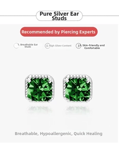 Macro detail of square cut emerald stones set in S925 sterling silver earrings