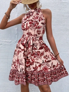 Close-up of floral halter neck dress featuring a waist drawstring and red-brown print