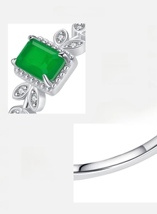 Macro shot of 925 sterling silver stamp and green zircon leaf design on women's ring