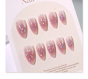Macro shot of 10-piece pink jelly gradient press-on nails with holographic heart sequins