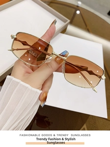 Detailed view of vintage gold metal frame sunglasses with amber gradient square lenses