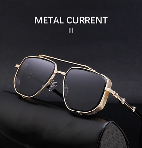 Close-up of golden metal frame sunglasses with intricate mechanical texture on temples