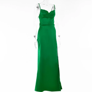 Detailed view of the sleek green satin fabric and high slit design of the evening gown