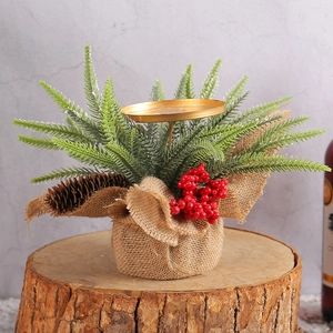 Christmas candle holder with red berries and pine cones on a wooden log base