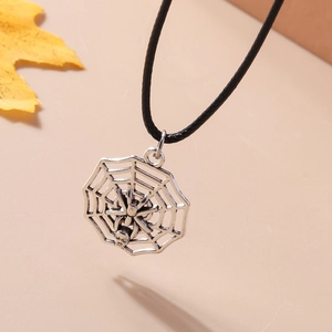 Macro view of silver spider and web pendant on a black cord necklace for Halloween