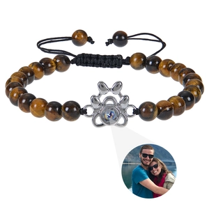 Detail view of tiger eye stone bracelet with silver alloy cat paw photo projection charm