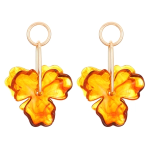 Macro detail of amber resin flower earrings with golden metal ring accents