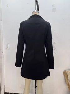 Detail view of the slim-fit black long-sleeve mini dress featuring a back zipper closure