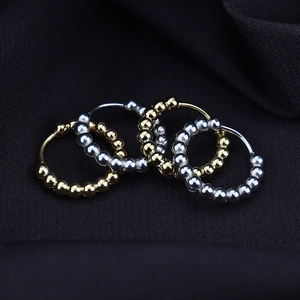 Minimalist egg-shaped beaded hoop earrings in polished gold and silver finishes