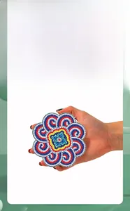 Macro shot of mandala acrylic diamond painting coaster with colorful floral patterns