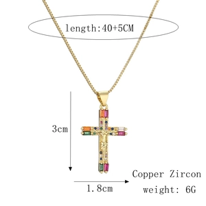 Detailed view of gold cross pendant with dimensions 3x1.8cm and 40+5cm chain length