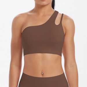 Detail of coffee brown one-shoulder sports bra with stylish cutout on the strap