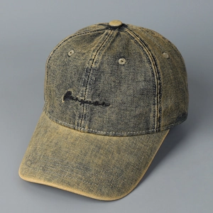Macro detail of washed denim baseball cap featuring embroidery and distressed texture
