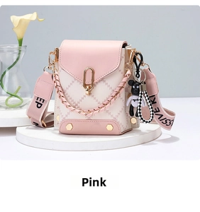 Pink and beige bucket bag with metal chain handle and wide graphic fabric shoulder strap