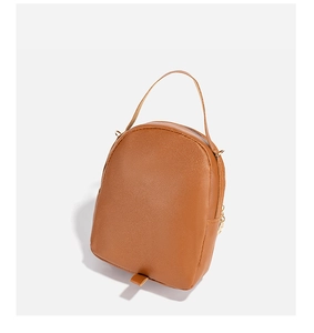 Close-up of brown litchi pattern faux leather texture and golden metal hardware hook