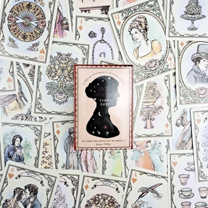 Flat lay of the Jane Austen Tarot Deck packaging and 53 illustrated cards for divination