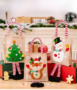 Three-piece burlap Christmas gift bags set with festive reindeer and snowman embroidery