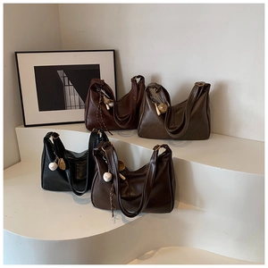 Detailed display of vintage tote bags in burgundy, dark green, black, and deep brown