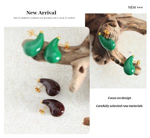 Detail view of water-drop earrings with green and burgundy enamel in gold plating