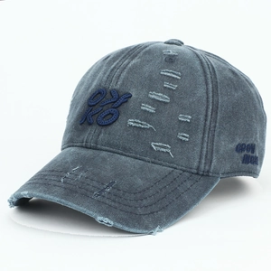 Detail of vintage washed grey baseball cap featuring OYKO embroidery and distressed rips