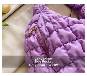 Detail view of purple quilted tote bag featuring a convenient side metal zipper pocket
