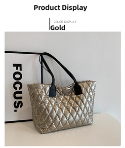 Detail view of gold metallic quilted tote bag with black faux leather handles