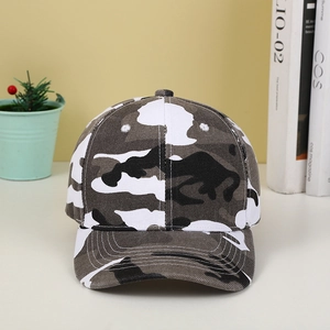 Detailed view of camouflage baseball cap with embroidery on a light wooden background