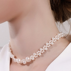 Elegant woven pearl choker necklace on a female model featuring high luster white beads